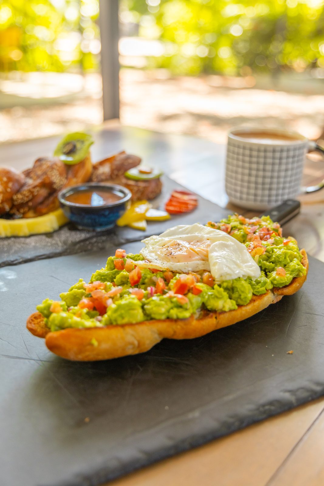 Avocado toast with a fried egg and coffee